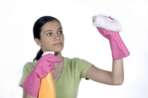 Cleaner wearing PPE while working carefully
